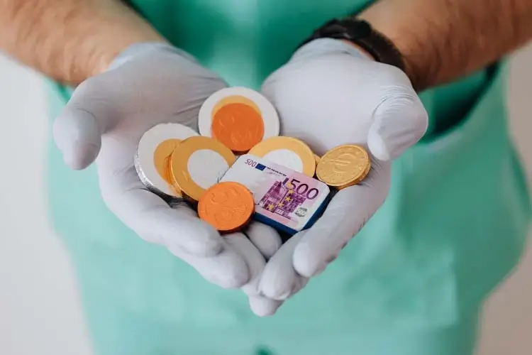 Doctor holding money to show hospital bill