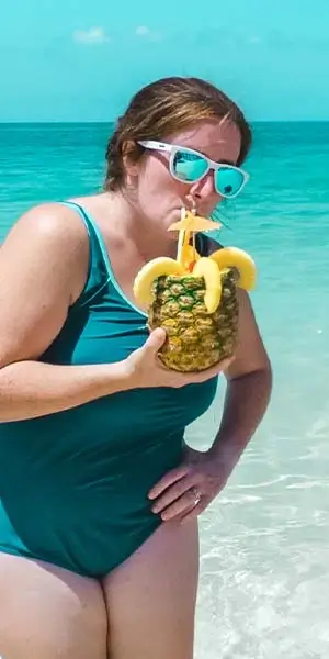 Photo of Charlotte Drinking from a pineapple at the beach