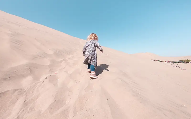 Huacachina desert with kids walking up